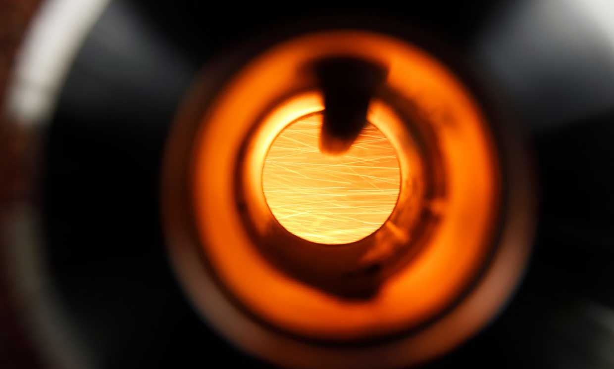 The combustion of the iron powder is visible through the glass in the combustion tube. 