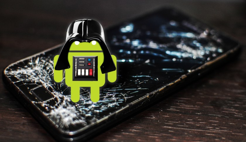 An Android robot standing atop a cracked mobile phone, wearing Darth Vader armor.