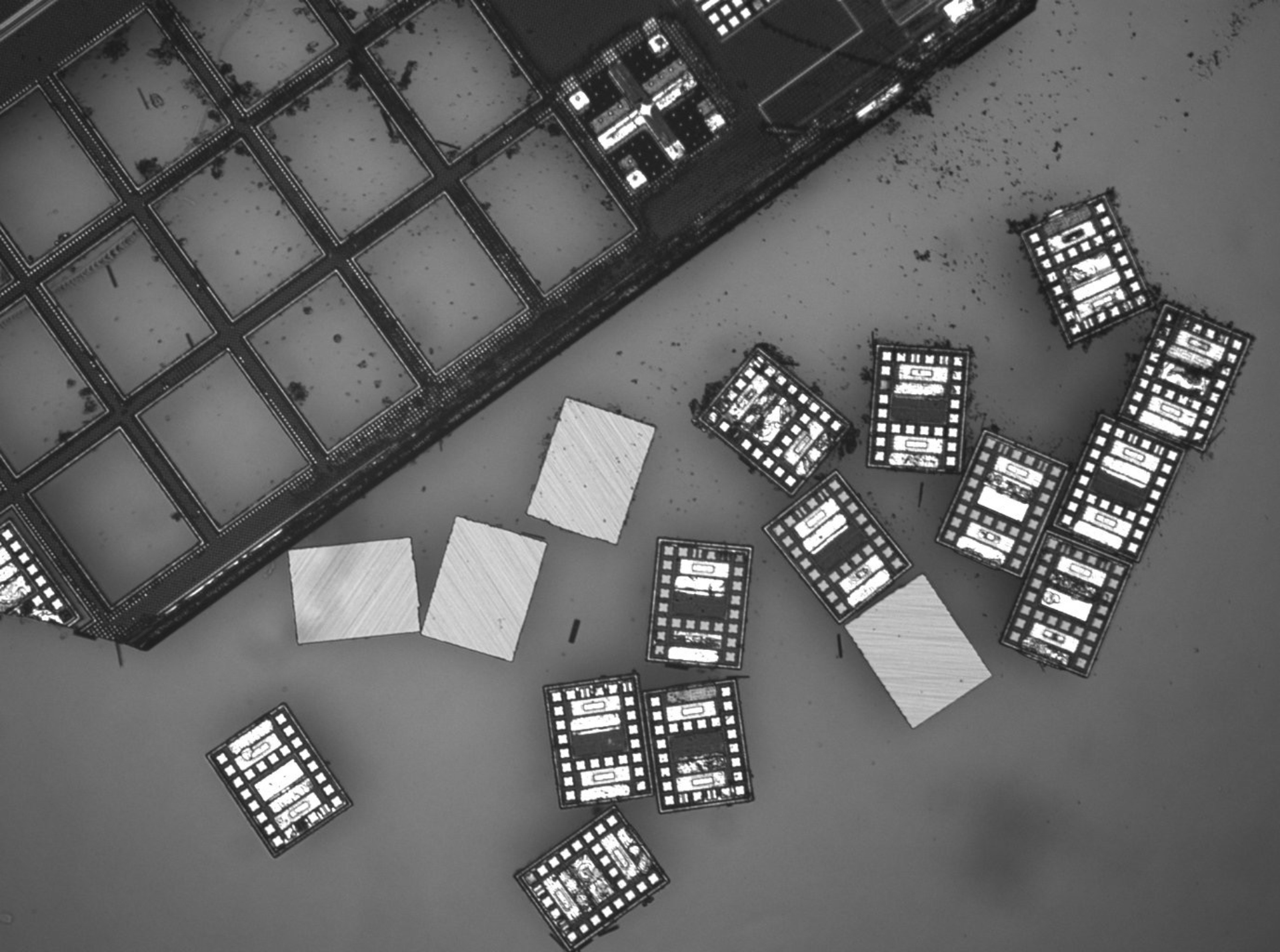 A wafer of robots, with some removed from the wafer leaving empty rectangles. 