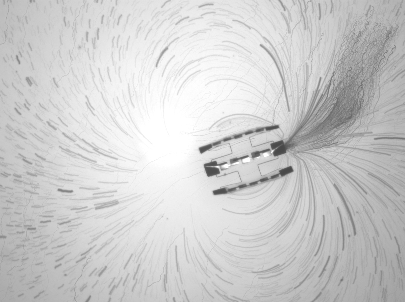 A robot surrounded by the curved lines of a field.